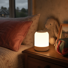 GlowRoam portable night light in a cosy guest bedroom
