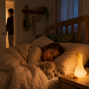 Sleeping child beside the warm Anseria goose night light – image 4