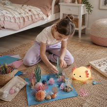 Child creating an ocean craft beside the LumaAxo axolotl night light