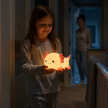 Child carrying the compact LumaAxo light during a quiet night-time walk