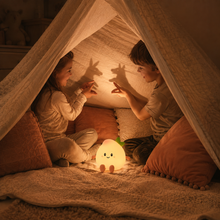 Children enjoying PeachLume as a gentle blanket-fort light