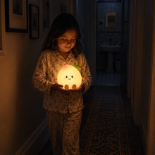 Child carrying rechargeable PeachLume through a dark hallway